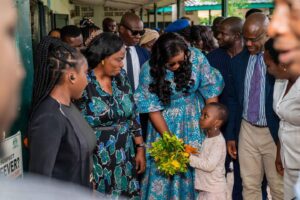 Young child welcomes her Excellency at the unveiling of additional facilities for the Health Insurance Programme